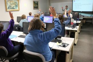 People in a classroom learning computer skills